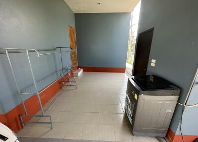 Utility room with washer and drying racks