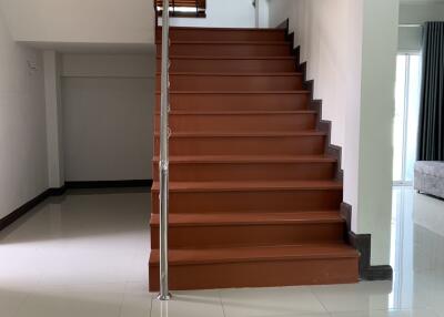 Staircase with wooden steps and metal railing