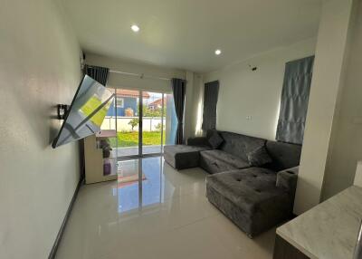 Modern living room with grey sofa and flat-screen TV