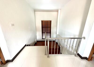 Interior staircase with railing and window