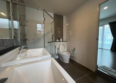 Modern bathroom with dual sinks and a shower