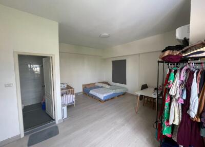 Spacious bedroom with bathroom and baby cot