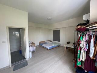 Spacious bedroom with bathroom and baby cot