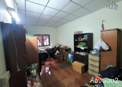 Cluttered bedroom with furniture and storage units