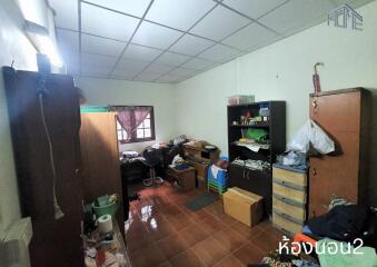 Cluttered bedroom with furniture and storage units