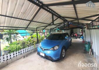 Covered carport with parked blue car