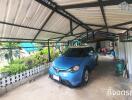 Covered carport with parked blue car