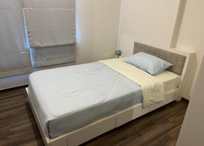 Bedroom with single bed, headboard, and window with blinds