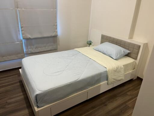 Bedroom with single bed, headboard, and window with blinds