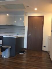 Modern kitchen with wooden floor and sleek cabinets