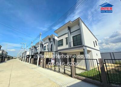 Row of modern townhouses with clear blue sky in the background