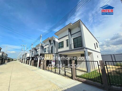 Row of modern townhouses with clear blue sky in the background