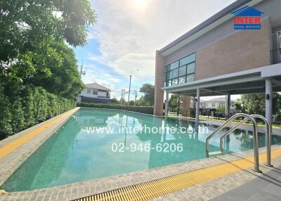 Outdoor swimming pool with a modern building adjacent