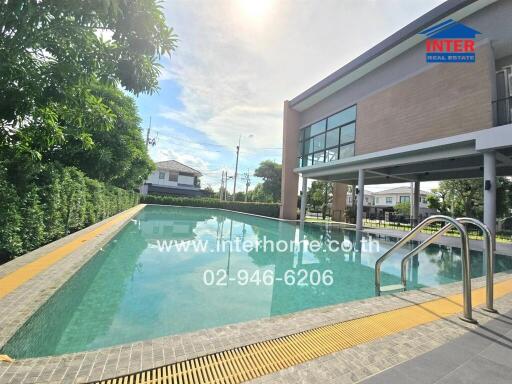 Outdoor swimming pool with a modern building adjacent