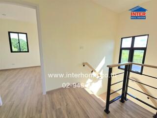 Bright stairway with wooden floors and railing in a modern home