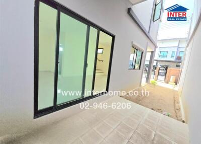 Outdoor area with sliding glass doors and tiled flooring