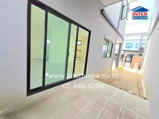 Outdoor area with sliding glass doors and tiled flooring