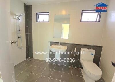 Modern bathroom with shower, sink, mirror and toilet