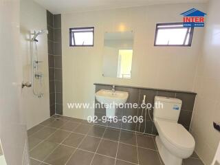 Modern bathroom with shower, sink, mirror and toilet