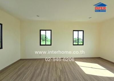 Spacious empty room with three windows