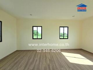 Spacious empty room with three windows