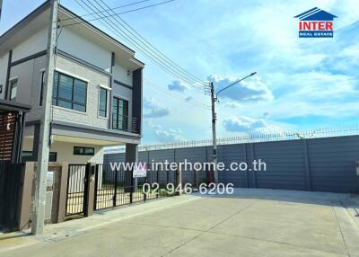 Two story house with a fenced yard and driveway