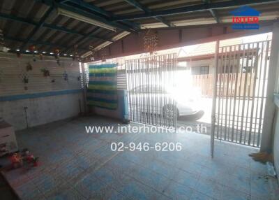 Covered garage with tiled floor