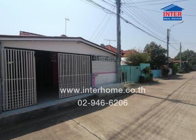 Front view of the property with gated entrance and residential street