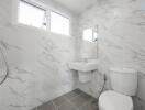 Modern bathroom with white marble tiles and fixtures