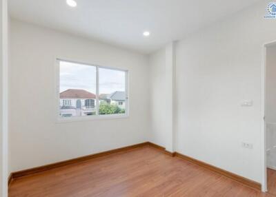 Empty bedroom with wooden floor and window