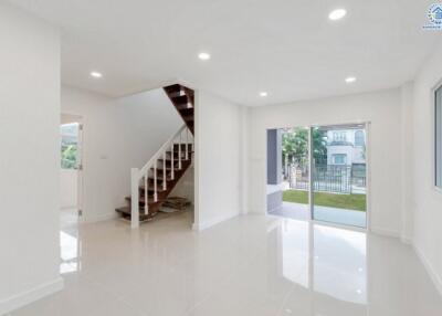 Bright living room with large windows and staircase