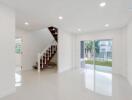 Bright living room with large windows and staircase