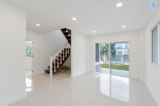 Bright living room with large windows and staircase