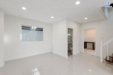 Modern living room with bright lighting and tiled floor