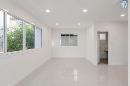 Bright, spacious living room with large windows