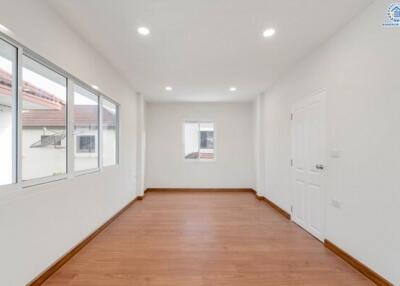 Spacious Room with Wooden Floor and Large Windows