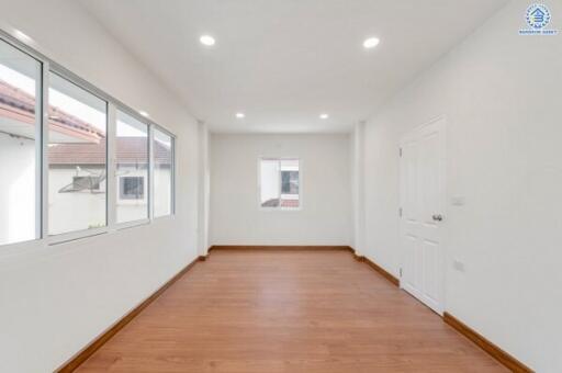 Spacious Room with Wooden Floor and Large Windows