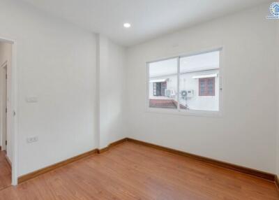 empty bedroom with wooden floor and window