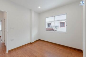 empty bedroom with wooden floor and window