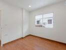 empty bedroom with wooden floor and window