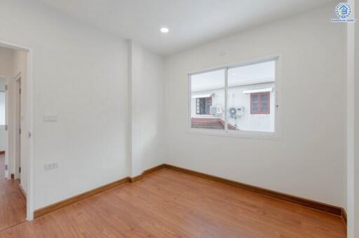 empty bedroom with wooden floor and window