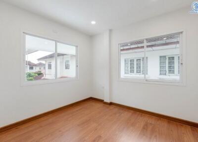 Spacious bedroom with large windows providing natural light