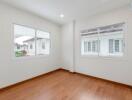 Spacious bedroom with large windows providing natural light