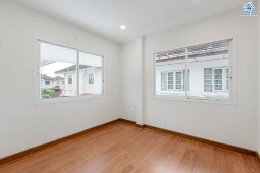 Spacious bedroom with large windows providing natural light