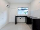 Minimalist kitchen with dark countertops and neutral walls