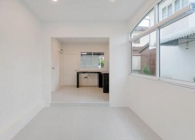 Modern white kitchen with large windows