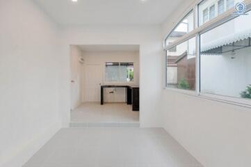 Modern white kitchen with large windows