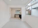 Modern white kitchen with large windows