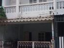 Two-story house with balcony and front yard