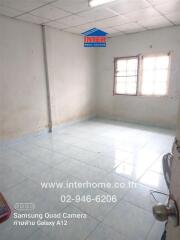 Empty room with tiled flooring and two windows